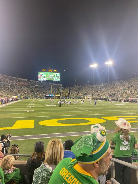 Field-level view of a night game at Autzen Stadium under the lights