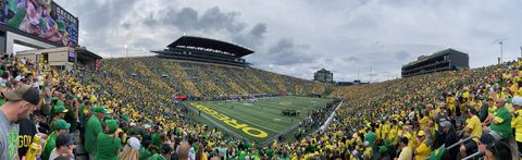 Panorama of a packed Autzen Stadium in green and yellow on game day