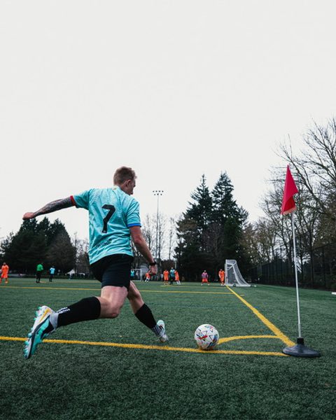 Hayden Schuster in a number 7 jersey taking a corner kick